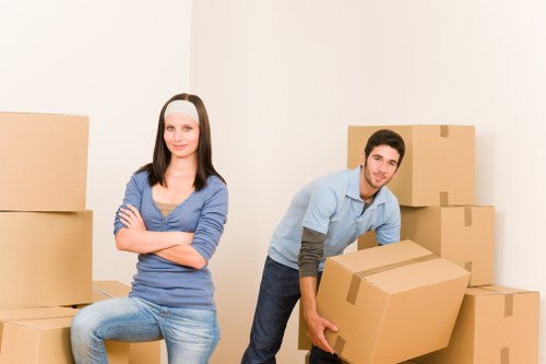 Professional movers carrying furniture through a Belgravia apartment building
