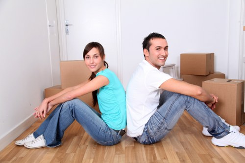 Movers handling boxes and household items inside a Belgravia property