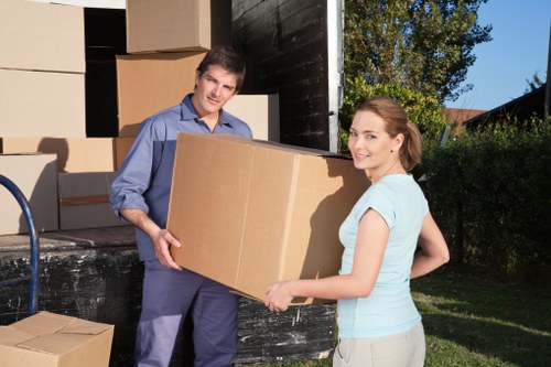 Professional movers loading boxes into a van in Belgravia